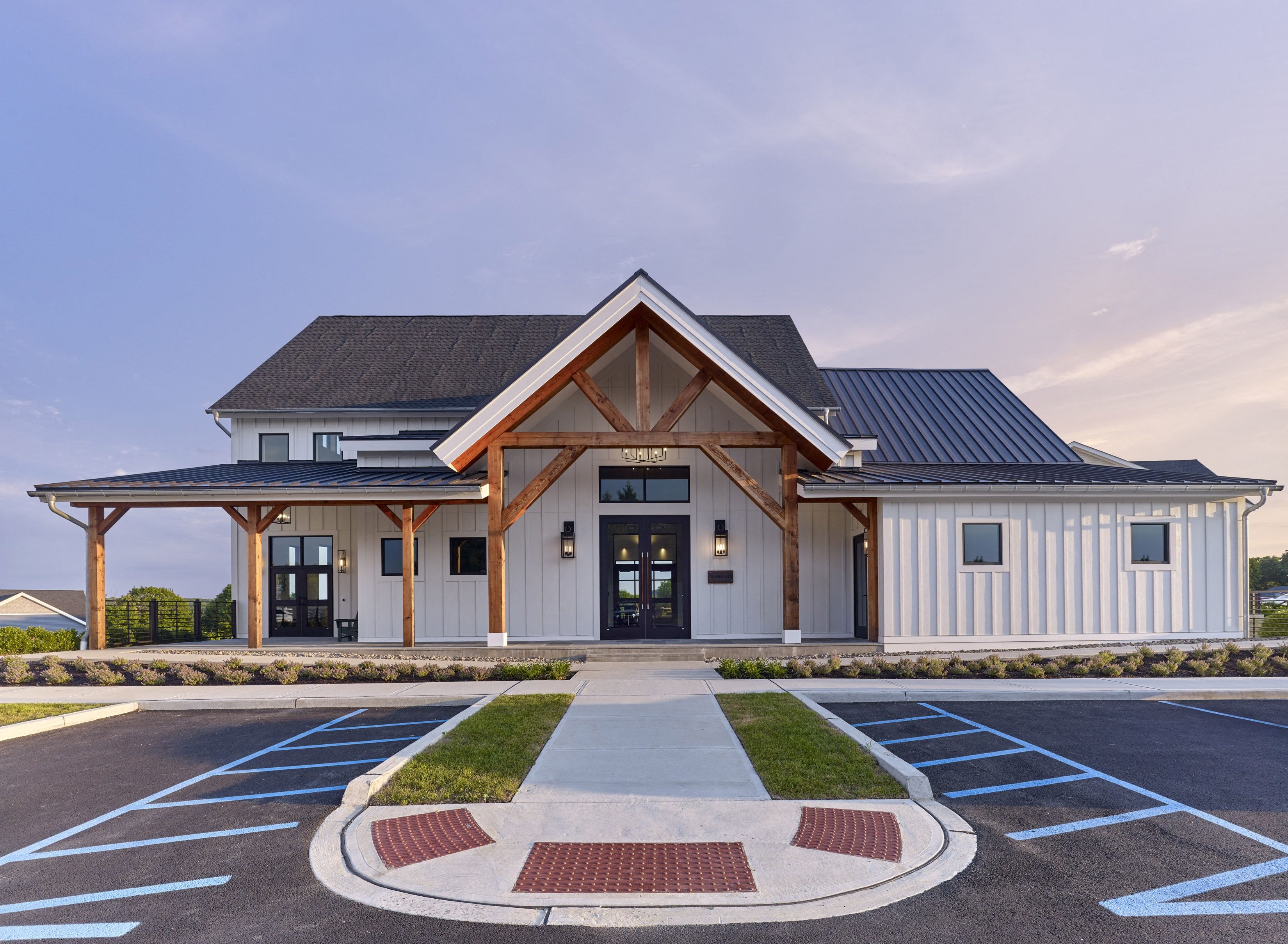 the facade of a building with a parking lot and a driveway